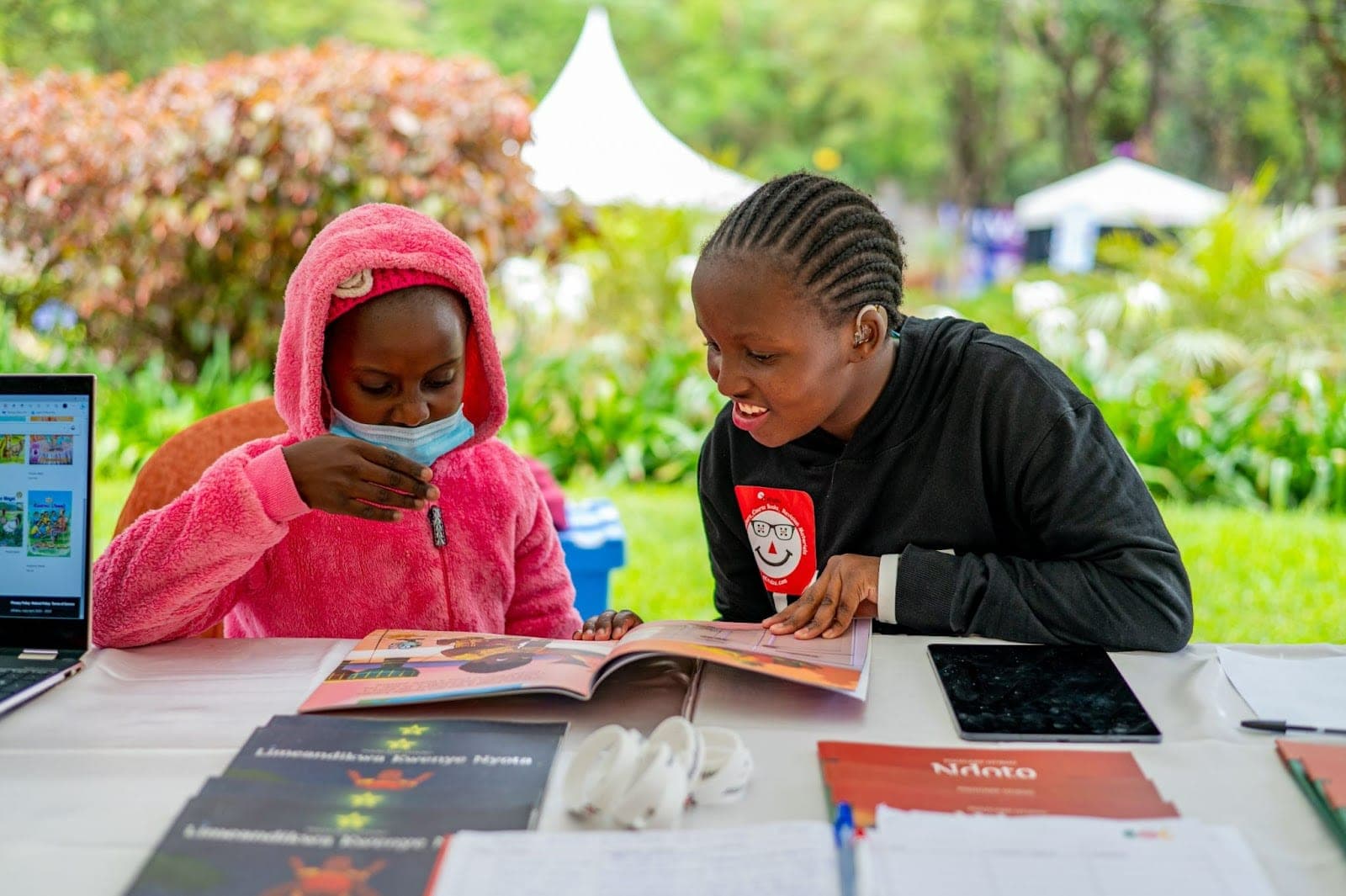 Children interacting with reading materials during the Sol Kids Easter Festival at The Hub, Karen.