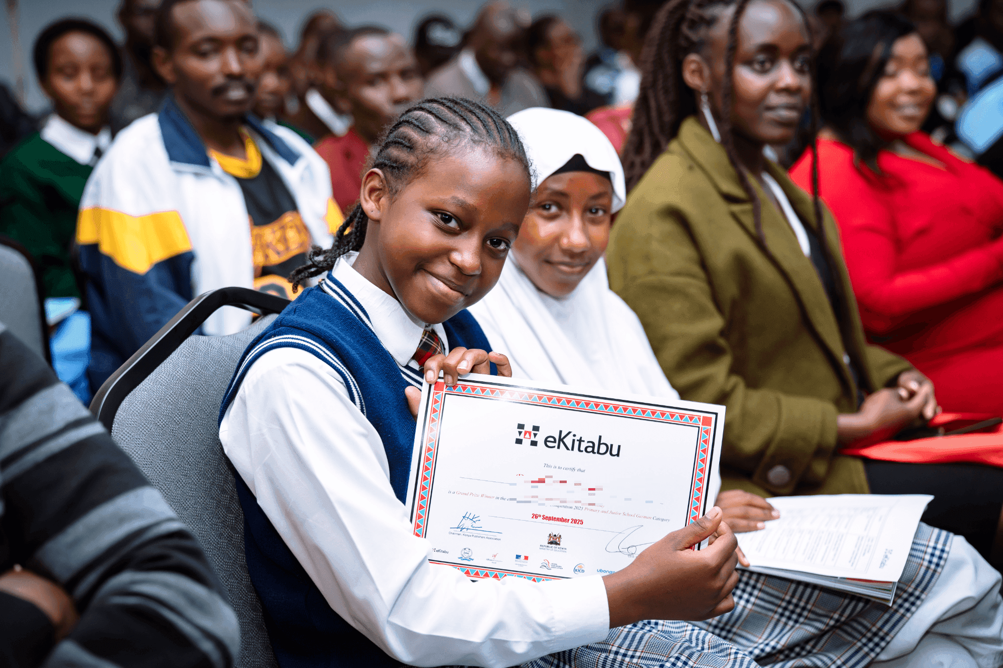 A Digital Essay Competition grand prize winner holding her eKitabu certificate